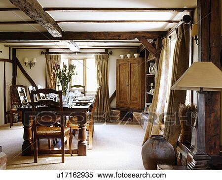 Cream carpet and large wooden table with ladderback chairs in country dining room with large corner cupboard View Large Photo Image Stock Photography - Cream carpet and large wooden table with ladderback chairs in country dining room with large corner cupboard. Fotosearch