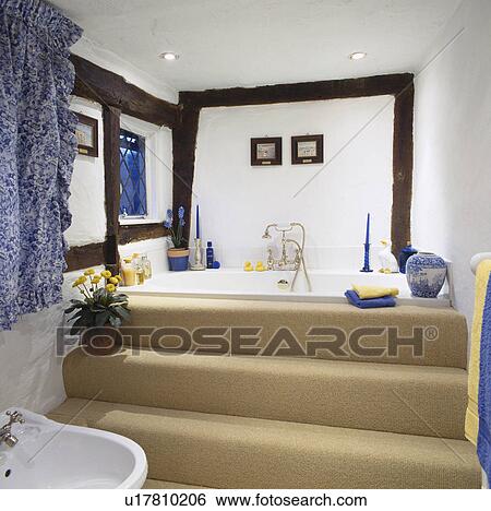 Cream carpet on steps up to platform bath in beamed country bathroom View Large Photo Image Stock Photograph - Cream carpet on steps up to platform bath in beamed country bathroom. Fotosearch