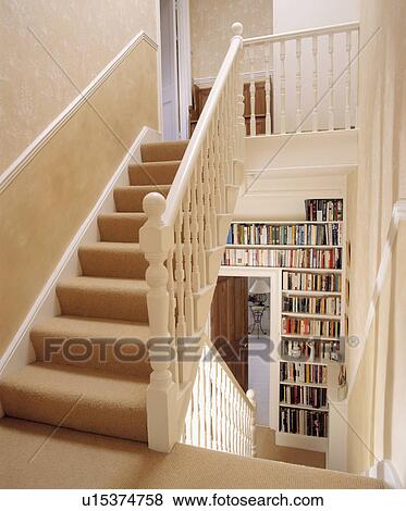 Cream carpet on white staircase with dado-rail and bookshelves on landing View Large Photo Image Stock Photo - Cream carpet on white staircase with dado-rail and bookshelves on landing. Fotosearch