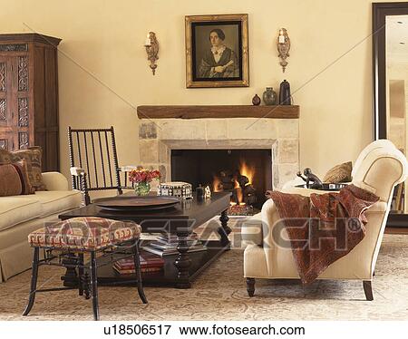 Cream sofas with throws and wooden coffee table in front of fireplace of contemporary cream livingroom View Large Photo Image Stock Photo - Cream sofas with throws and wooden coffee table in front of fireplace of contemporary cream livingroom. Fotosearch
