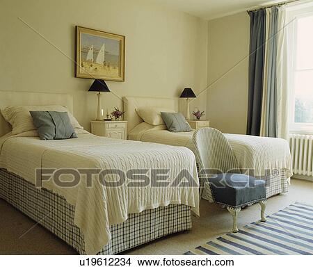 Cream woollen blankets on twin beds with checked vallances in cream bedroom View Large Photo Image Picture - Cream woollen blankets on twin beds with checked vallances in cream bedroom. Fotosearch