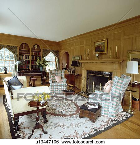 Cream+brown patterned rug in traditional panelled country living room View Large Photo Image Stock Photograph - Cream+brown patterned rug in traditional panelled country living room. Fotosearch