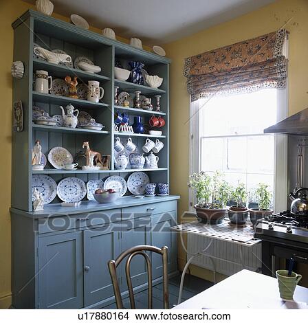 Crockery and china on large blue painted dresser in traditional kitchen View Large Photo Image Picture - Crockery and china on large blue painted dresser in traditional kitchen. Fotosearch