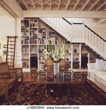 Cube shelving below staircase in traditional living room with oriental carpet View Large Photo Image Picture - Cube shelving below staircase in traditional living room with oriental carpet. Fotosearch