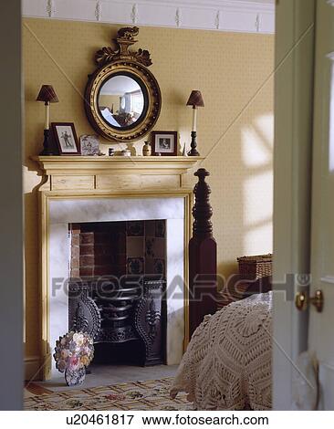 Door Open To Small Traditional Bedroom With Antique Gilt Mirror