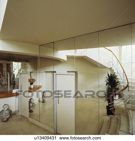 Stock Image - Doors in mirrored wall in thirties style white hall . Fotosearch