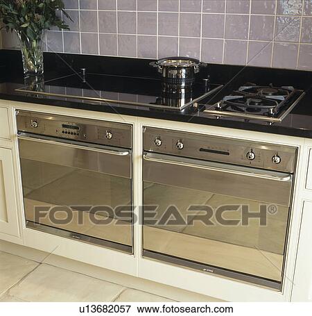 Double chrome oven below gas and halogen hobs View Large Photo Image Stock Photo - Double chrome oven below gas and halogen hobs. Fotosearch