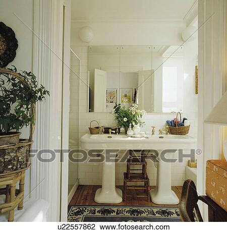 Double pedestal basins below mirror in traditional white bathroom View Large Photo Image Stock Image - Double pedestal basins below mirror in traditional white bathroom. Fotosearch