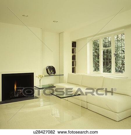 Stock Image - Fireplace in modern white living room with white sofa. Fotosearch