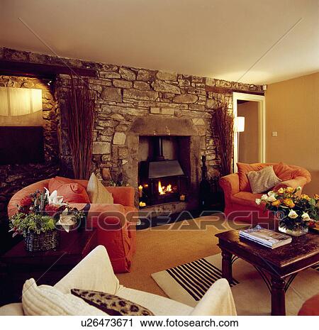 Stock Image - Fireplace in traditional country living room. Fotosearch