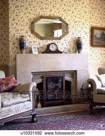 Stock Image - Firescreen in front of fireplace in traditional living room. Fotosearch