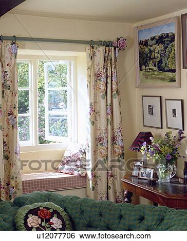 Floral curtains at window with checked windowseat in cottage living room View Large Photo Image Stock Photograph - Floral curtains at window with checked windowseat in cottage living room. Fotosearch