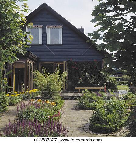 Flower beds in paving in front of modern house in summer View Large Photo Image Stock Photo - Flower beds in paving in front of modern house in summer. Fotosearch