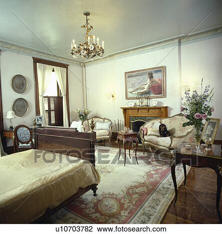 French antique furniture in traditional bedroom with Chinese silk carpet and ornate brass chandelier View Large Photo Image Stock Image - French antique furniture in traditional bedroom with Chinese silk carpet and ornate brass chandelier . Fotosearch