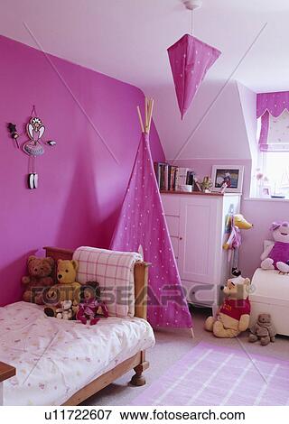 Fuchsia pink wigwam and wall in child's bedroom with teddybears and white chest-of-drawers View Large Photo Image Stock Photo - Fuchsia pink wigwam and wall in child's bedroom with teddybears and white chest-of-drawers. Fotosearch