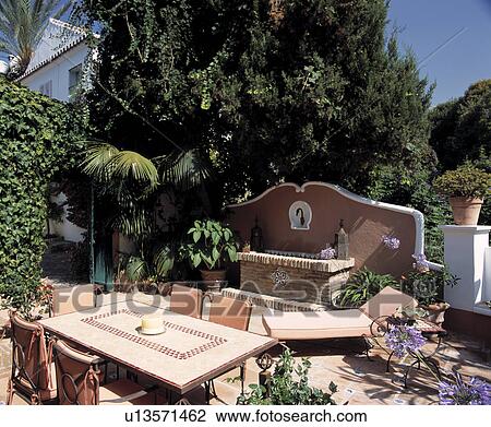 Furniture on patio in country garden in summer View Large Photo Image Stock Image - Furniture on patio in country garden in summer. Fotosearch