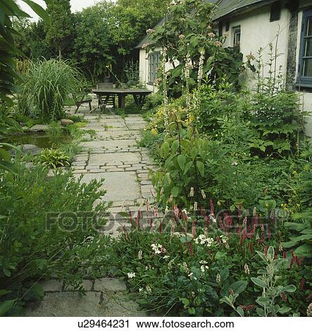 Furniture on patio in country garden in summer View Large Photo Image Stock Image - Furniture on patio in country garden in summer. Fotosearch