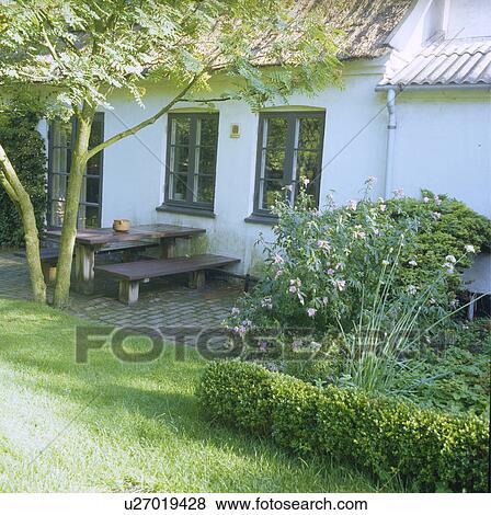 Furniture on patio in country garden in summer View Large Photo Image Stock Photo - Furniture on patio in country garden in summer. Fotosearch