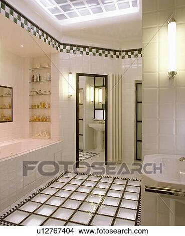 Glass brick flooring in modern white tiled bathroom with black+white chequerboard tiling border below ceiling View Large Photo Image Picture - Glass brick flooring in modern white tiled bathroom with black+white chequerboard tiling border below ceiling . Fotosearch