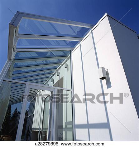 Stock Photograph - Glass extension on modern white architectural house in the country. Fotosearch