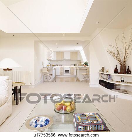 Glass table in living area of modern openplan apartment in small loft conversion View Large Photo Image Stock Photograph - Glass table in living area of modern openplan apartment in small loft conversion. Fotosearch