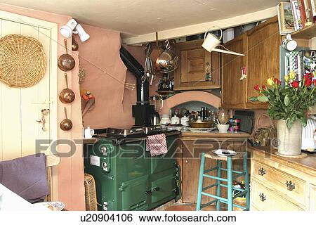 Green Aga and turquoise wooden stool in corner of pink cottage kitchen View Large Photo Image Stock Photograph - Green Aga and turquoise wooden stool in corner of pink cottage kitchen. Fotosearch