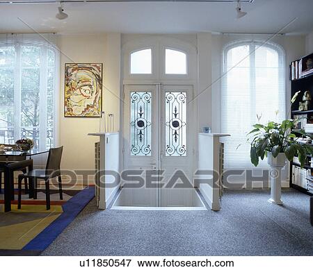 Grey carpet and double white doors with glass panels in white hall dining room with white slatted blinds on windows View Large Photo Image Stock Photo - Grey carpet and double white doors with glass panels in white hall dining room with white slatted blinds on windows. Fotosearch