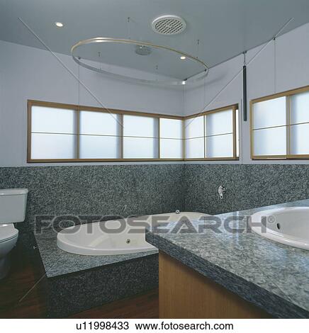 Grey granite walls to dado height in modern bathroom with white blinds on narrow windows View Large Photo Image Stock Image - Grey granite walls to dado height in modern bathroom with white blinds on narrow windows. Fotosearch