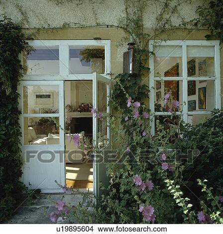 Half-glazed door on traditional country house in France with white shutters View Large Photo Image Picture - Half-glazed door on traditional country house in France with white shutters. Fotosearch