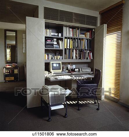 Stock Photograph - Hide your work away in this compactly designed home office.. Fotosearch