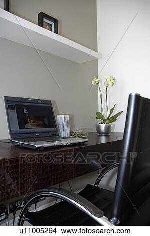 Laptop computer on leather desk in modern home office View Large Photo Image Picture - Laptop computer on leather desk in modern home office. Fotosearch