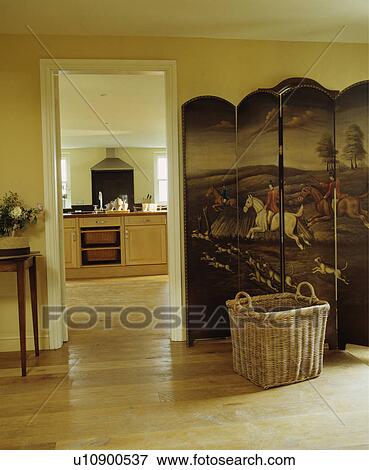 Large basket in front of antique pictorial folding screen beside open doorway with view of neutral kitchen View Large Photo Image Stock Photo - Large basket in front of antique pictorial folding screen beside open doorway with view of neutral kitchen. Fotosearch