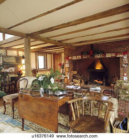 Large fireplace in livingroom with antique dropleaf table and wooden chairs behind sofa View Large Photo Image Stock Photo - Large fireplace in livingroom with antique dropleaf table and wooden chairs behind sofa. Fotosearch