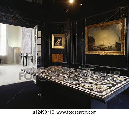 Large painting on black panelled wall in dining room with ornately inlaid table View Large Photo Image Stock Image - Large painting on black panelled wall in dining room with ornately inlaid table. Fotosearch