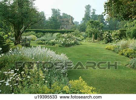 Lawn and herbaceous border in large country garden in summer View Large Photo Image Stock Image - Lawn and herbaceous border in large country garden in summer. Fotosearch