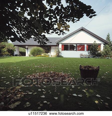 Stock Photograph - Lawn in front of modern country house in summer. Fotosearch