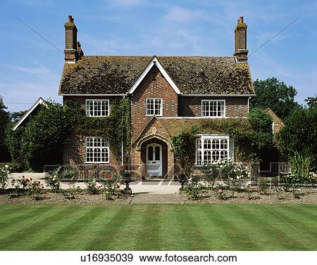 Lawn in front of traditional brick country cottage View Large Photo Image Stock Photo - Lawn in front of traditional brick country cottage. Fotosearch