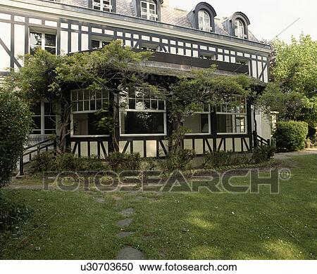 Lawn in front of traditional black+white country house in France with white shutters View Large Photo Image Stock Image - Lawn in front of traditional black+white country house in France with white shutters. Fotosearch
