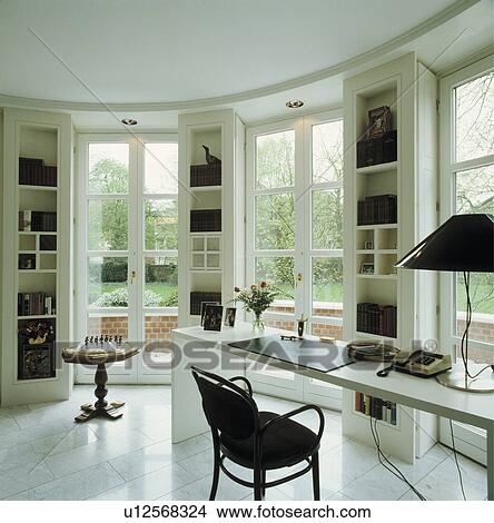 Picture - Light and airy office in modern german house with clever storage between ceiling to floor windows.. Fotosearch