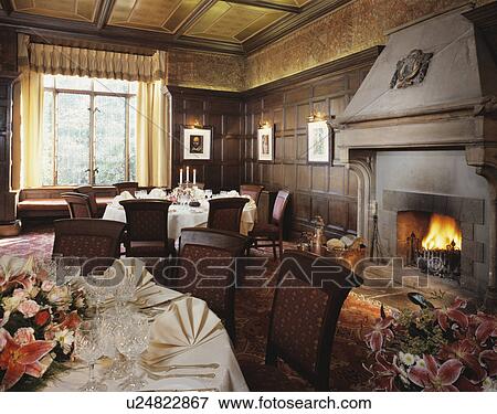 Lighted fire in fireplace of panelled dining room in country hotel View Large Photo Image Stock Photo - Lighted fire in fireplace of panelled dining room in country hotel. Fotosearch