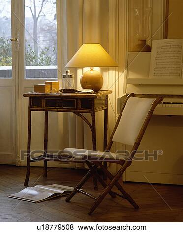 Stock Photo - Lighted lamp on table. Fotosearch