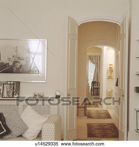 Living room with double doors open to hall with oriental carpets on cream carpet View Large Photo Image Stock Photography - Living room with double doors open to hall with oriental carpets on cream carpet. Fotosearch
