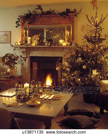 Stock Photography - Livingroom decorated for Christmas and lit with candles.. Fotosearch