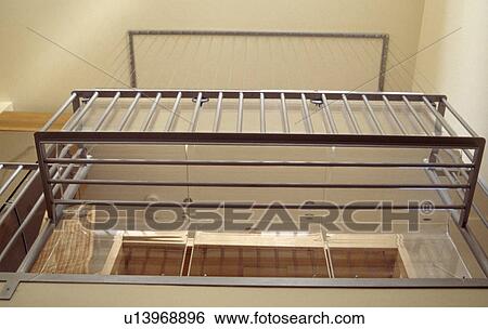 Looking up at metal railings of landing in modern hall View Large Photo Image Stock Photograph - Looking up at metal railings of landing in modern hall. Fotosearch
