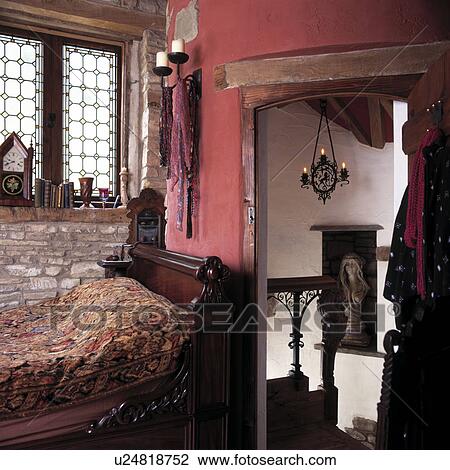 Mahogany single bed between window and open door in small dark pink bedroom View Large Photo Image Stock Image - Mahogany single bed between window and open door in small dark pink bedroom. Fotosearch