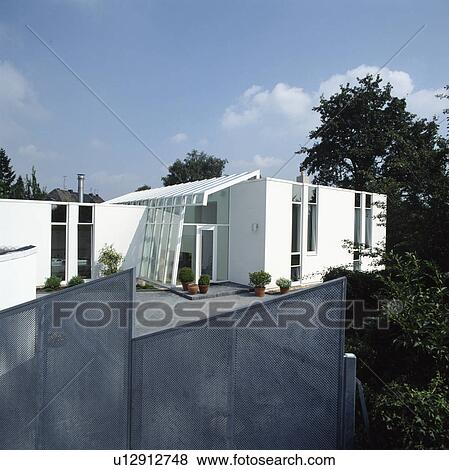 Metal mesh fence on garden of modern white house in the country View Large Photo Image Stock Photo - Metal mesh fence on garden of modern white house in the country. Fotosearch