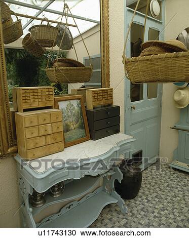 Miniature chests of drawers on marble-topped pastel blue Edwardian cupboard below mirror in small hall View Large Photo Image Stock Image - Miniature chests of drawers on marble-topped pastel blue Edwardian cupboard below mirror in small hall. Fotosearch