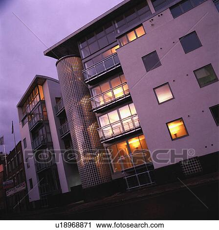 Modern apartment building lit at night View Large Photo Image Stock Image - Modern apartment building lit at night. Fotosearch