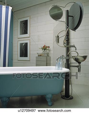 Modern designer bathroom with a roll-top bath and freestanding basin and vanity View Large Photo Image Stock Photo - Modern designer bathroom with a roll-top bath and freestanding basin and vanity. Fotosearch