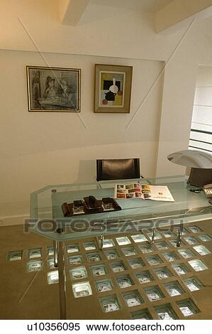 Stock Photography - Modern office with glass bricks in floor and glass desk.. Fotosearch